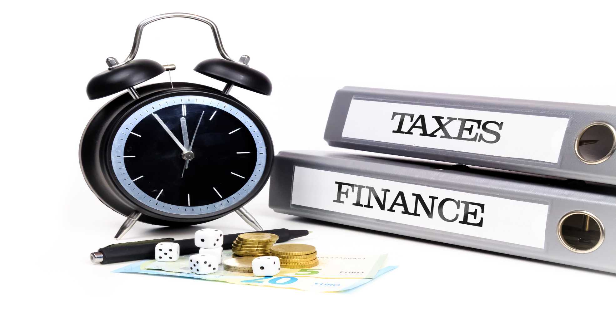 File folders and alarm clock symbolize time pressure while working on taxes and finance.